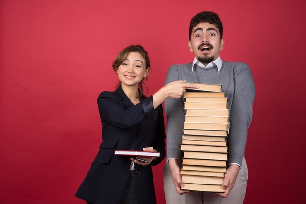 Woman employee taking book from her colleague