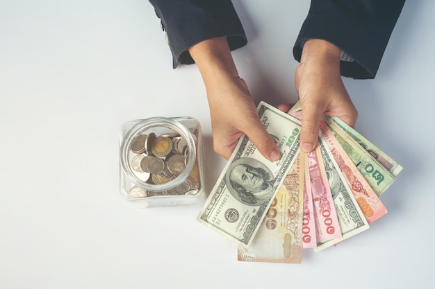 woman employees counting money on a white desk