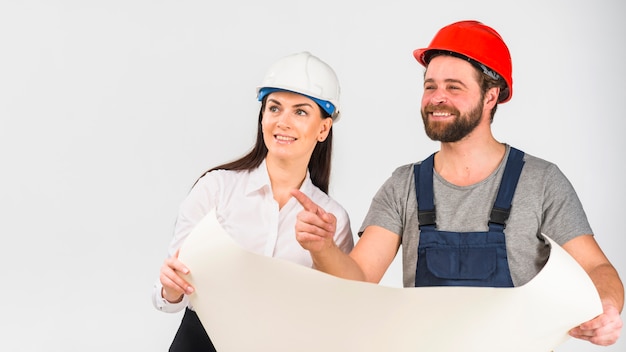 Woman engineer and builder discussing project pointing finger away