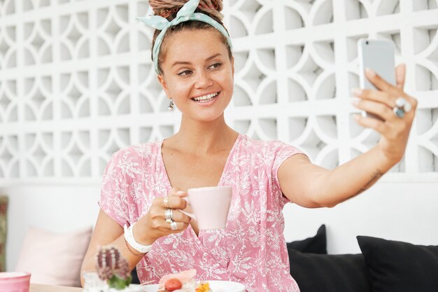 Woman enjoying dessert and drink in cafe