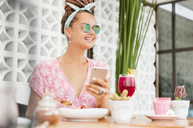 Woman enjoying dessert and drink in cafe