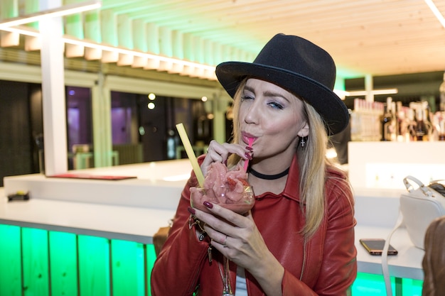 Woman enjoying dessert near bar