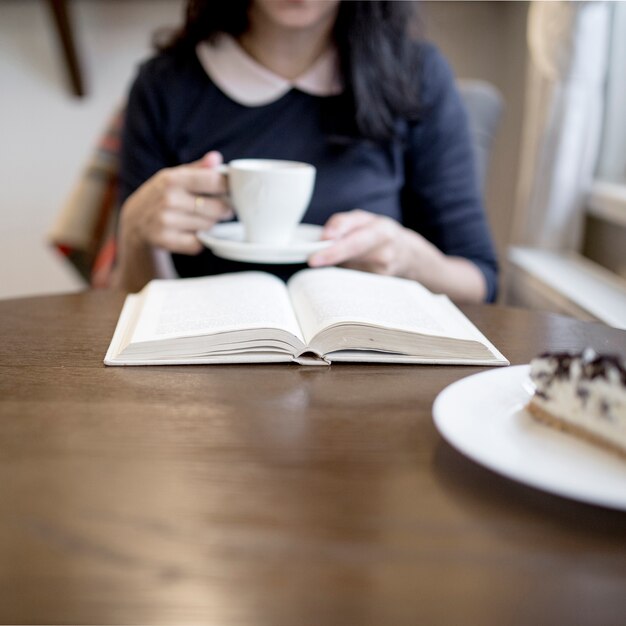 Woman enjoying drink while reading