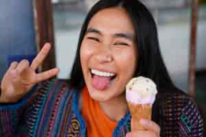 Free photo woman enjoying ice cream outdoors