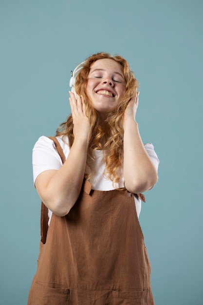 Free photo woman enjoying music on headphones