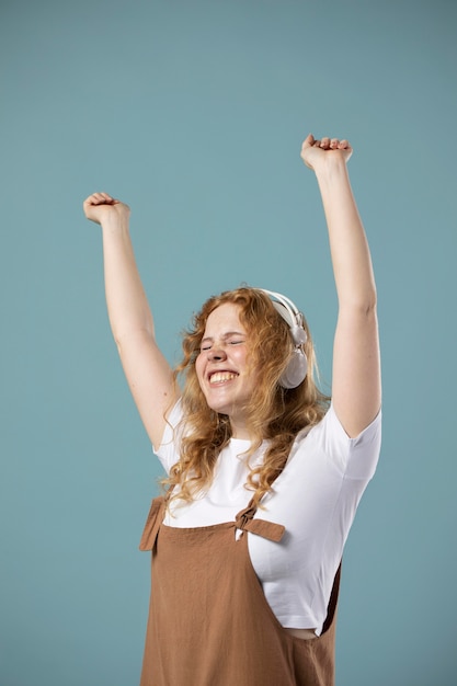 Free photo woman enjoying music on headphones