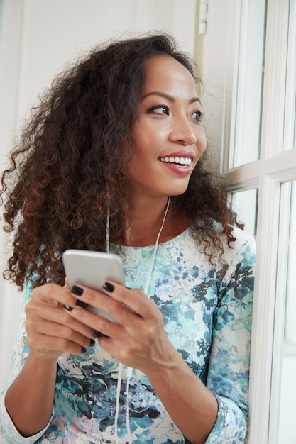 Woman enjoying the music on smartphone