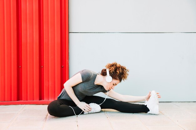 Woman enjoying music and stretching