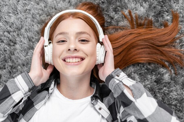 Woman enjoying music top view