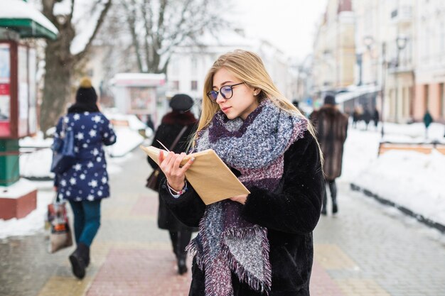 Woman enjoying reading in winter