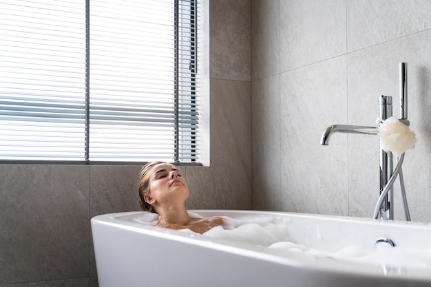 Woman enjoying a relaxing bubble bath