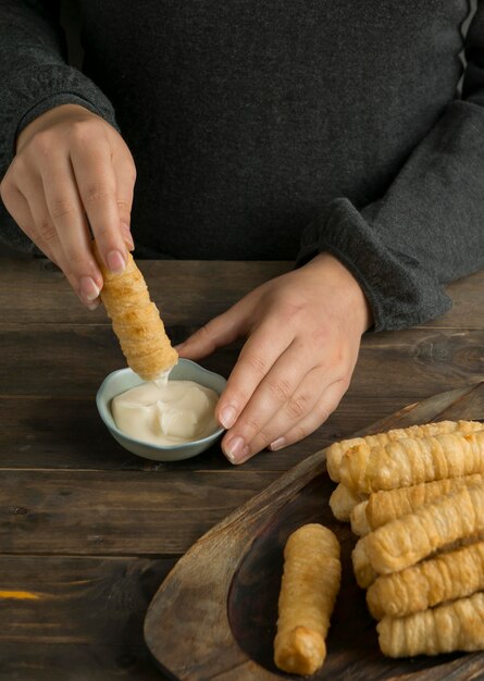 Woman enjoying some traditional tequenos