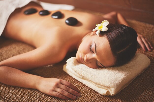 woman enjoying a stone massage