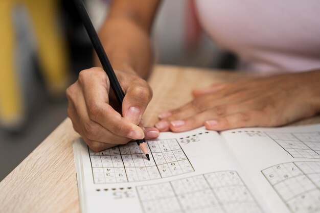 Woman enjoying a sudoku game alone