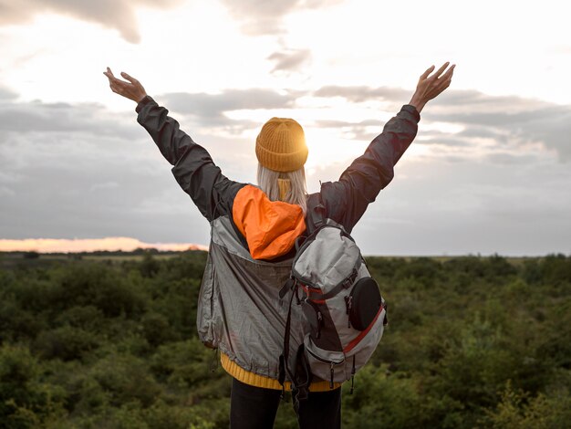 Free photo woman enjoying sunset on mountain