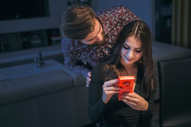 Woman enjoying surprising gift on date