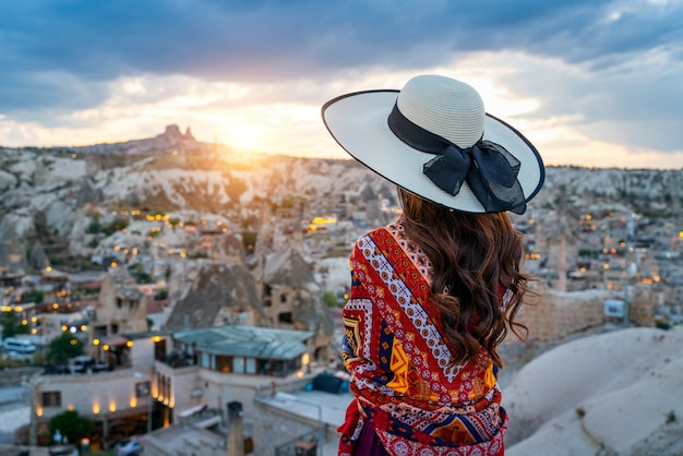 Woman enjoying view of Goreme town, Cappadocia in Turkey.