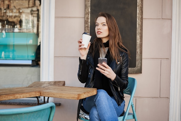 Woman enjoying warm and refreshing cup of coffee during lunch.