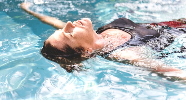 Woman enjoying the water in a swimming pool