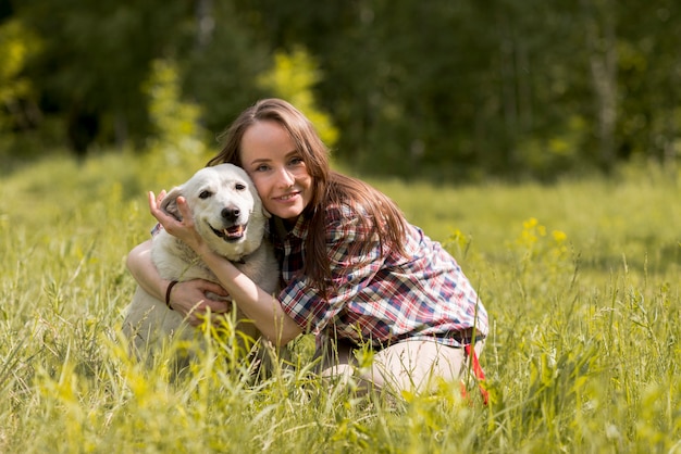 Woman enjoying with a dog in the countryside – Free Download