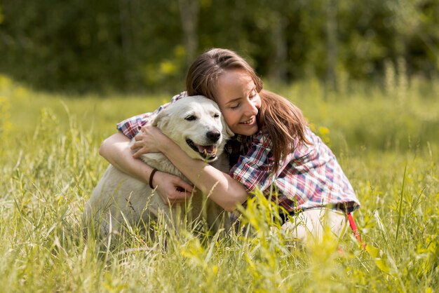 Woman enjoying with a dog in the countryside