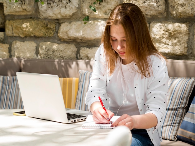 Woman enjoying working outdoors with laptop