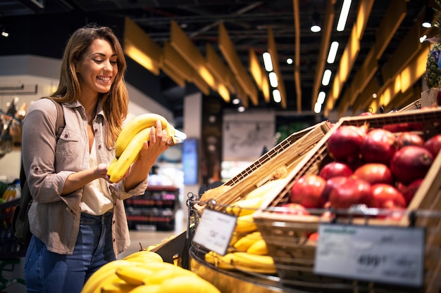 Woman enjoys buying healthy food in supermarket