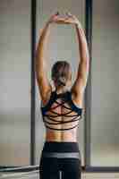 Free photo woman exercising pilates on the reformer