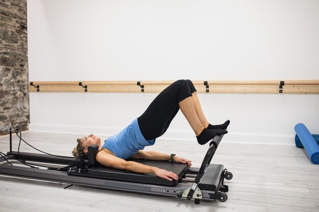 Woman exercising on reformer