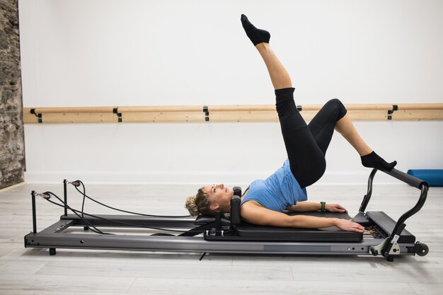 Woman exercising on reformer