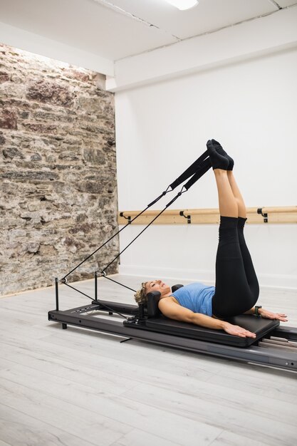 Woman exercising on reformer