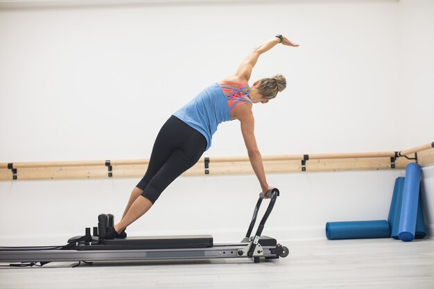 Woman exercising on reformer