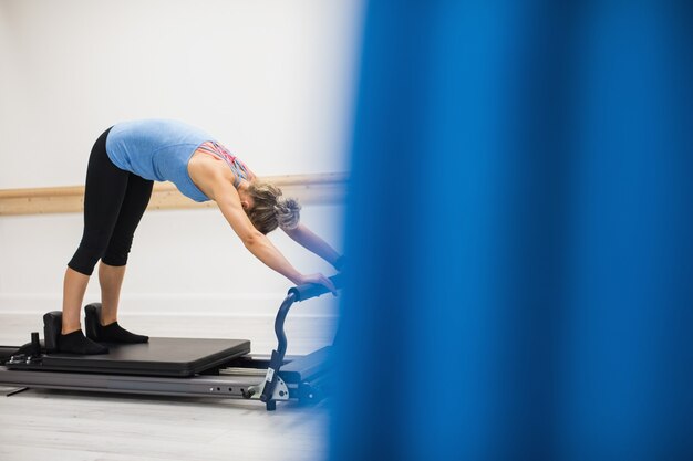 Woman exercising on reformer