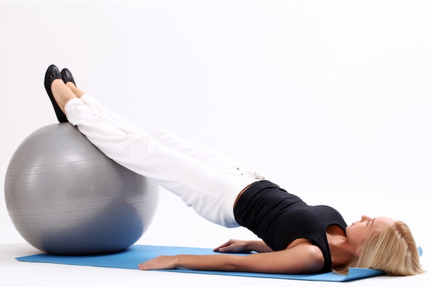 Woman exercising with fitness ball.