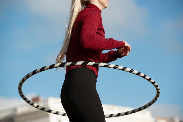 Woman exercising with hula hoop circle