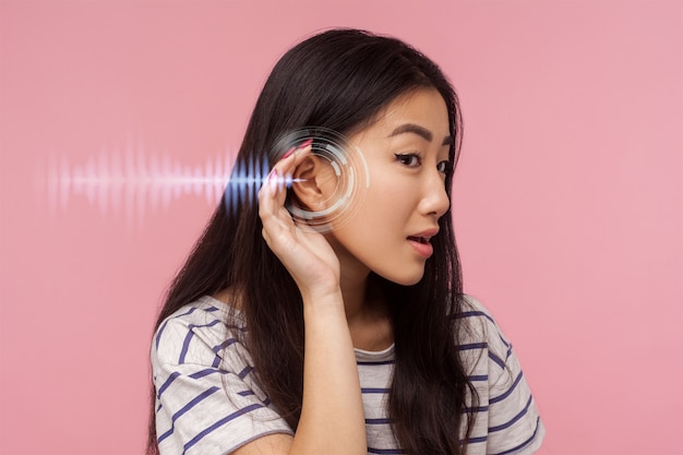 Woman experiencing hearing issues side view