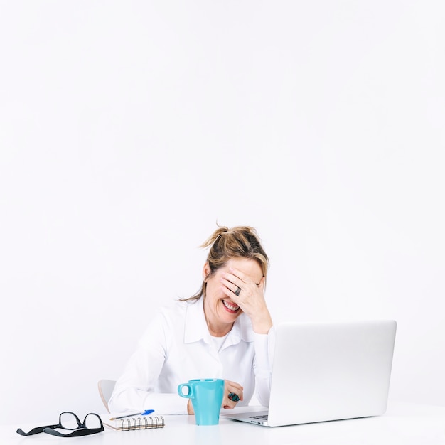 Woman facepalming at workplace