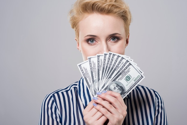 Woman behind a fan of money
