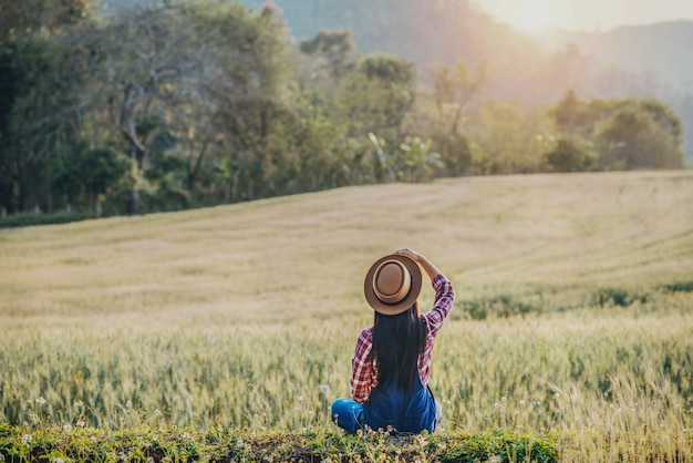 Woman farmer with barley field harvesting season