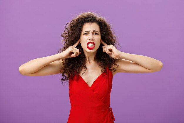 Woman fed up of hearing cursing words and arguments in her turn portrait of displeased insecure and ...