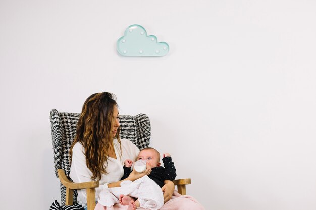 Woman feeding baby under cloud