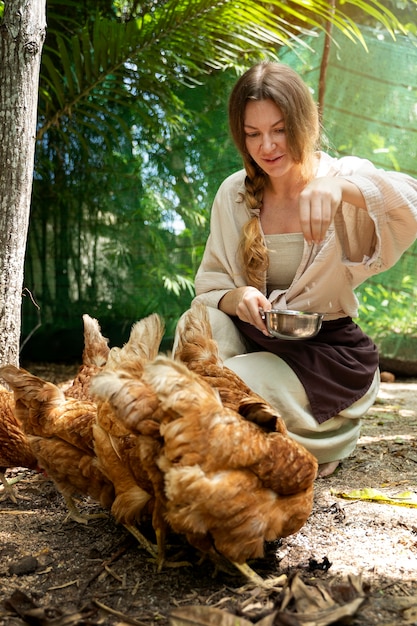 Woman feeding the birds full shot