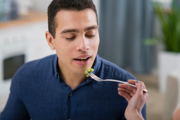 Woman feeding her boyfriend at a romantic dinner