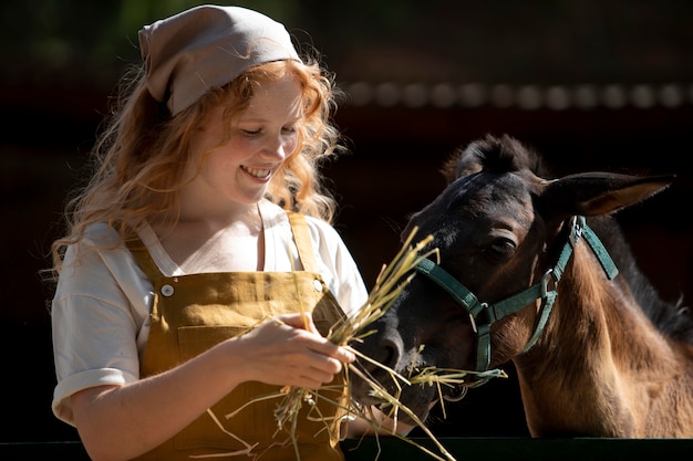 Woman feeding horse medium shot