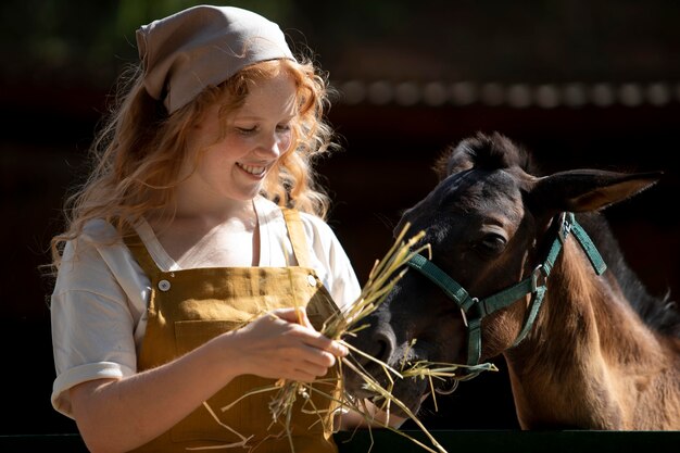 Woman feeding horse medium shot