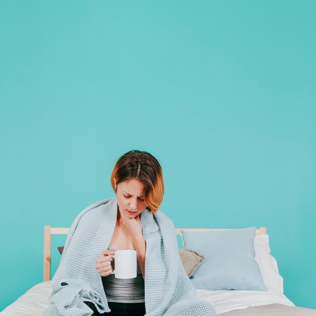 Woman feeling sick on bed