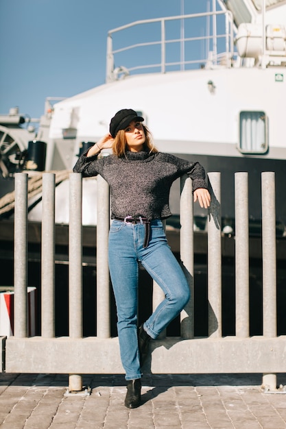 Woman at fence in front of ship