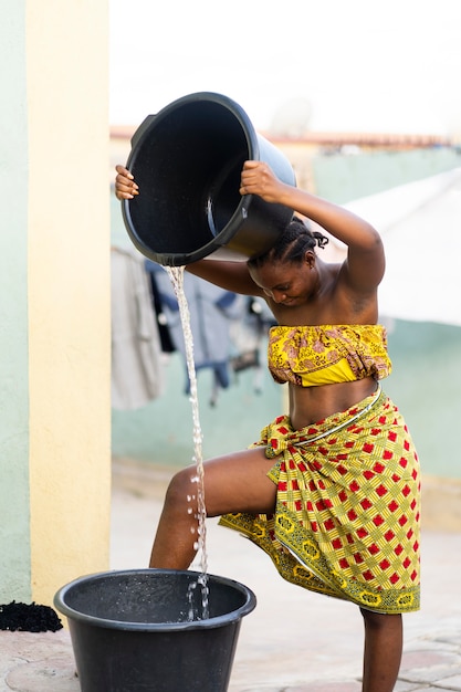 Woman fetching water from outdoors