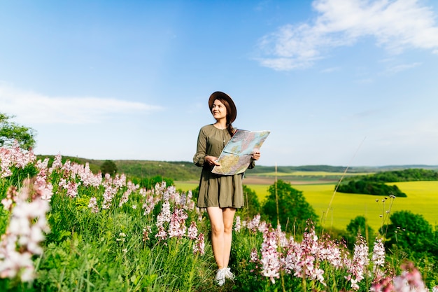 Woman on field navigating with map