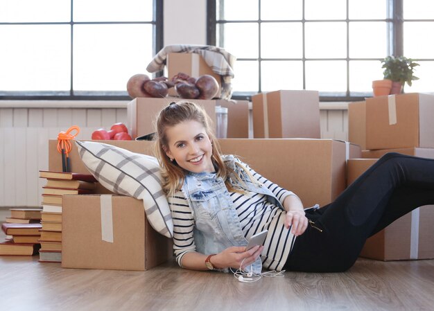 Woman finished with cargo packages and is chatting at her phone